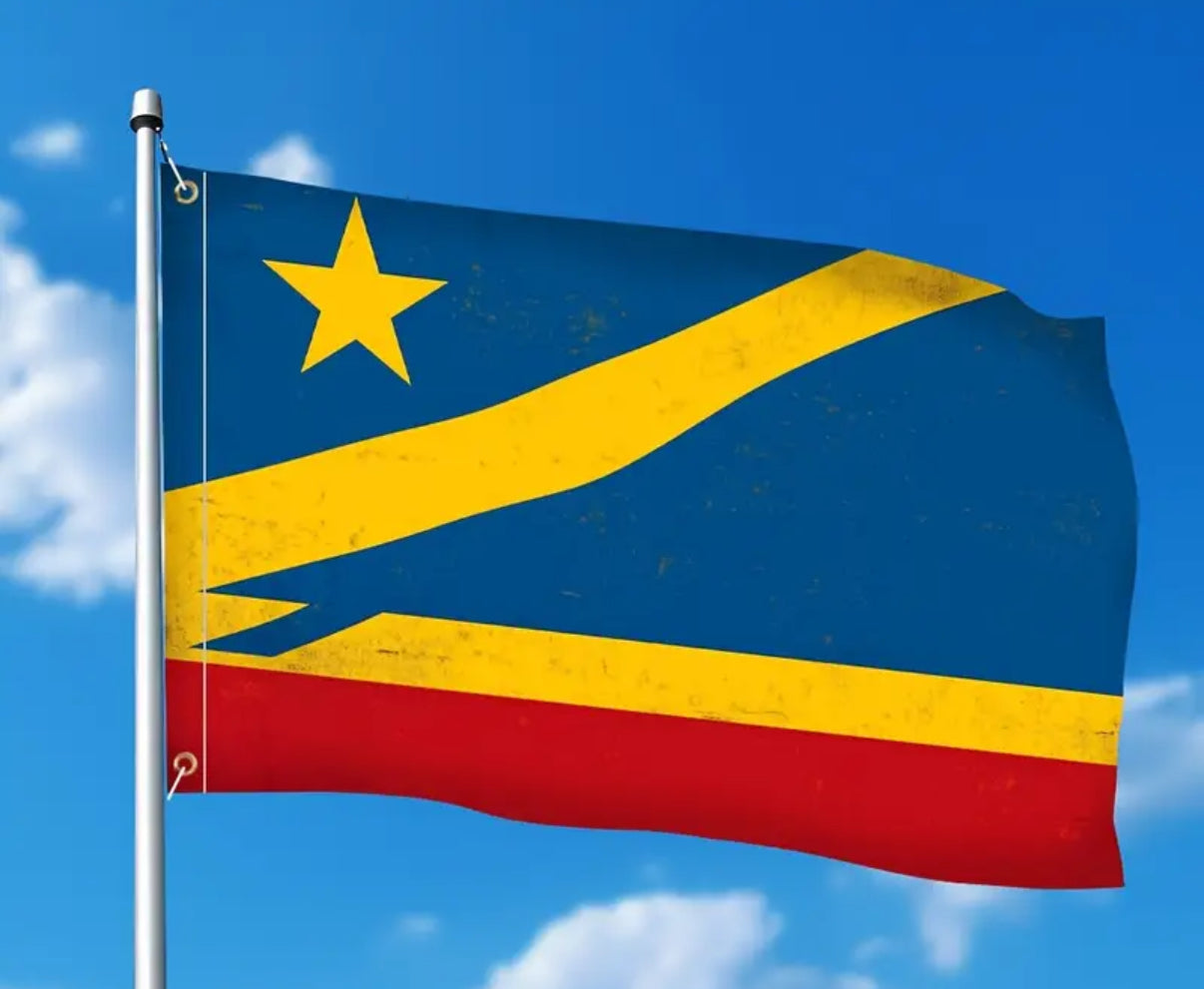 Flag with blue, yellow, and red colors against a clear blue sky.