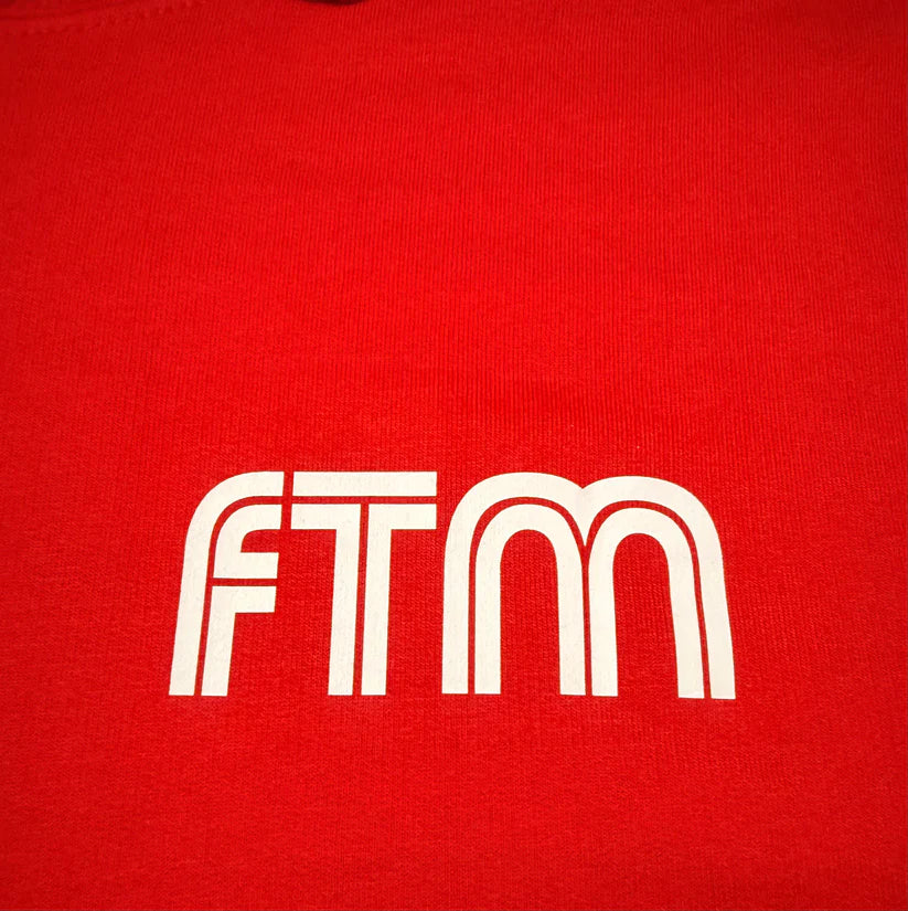 Red shirt with 'FTM' logo in white
