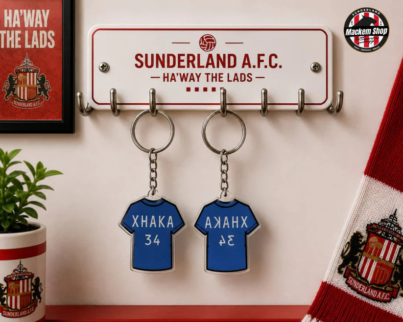 Two blue Xhaka 34 Keychains.