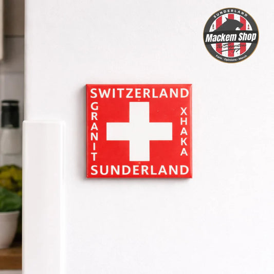 Rectangular sign with Swiss cross and text on a white surface, featuring the Mackem Shop logo.
