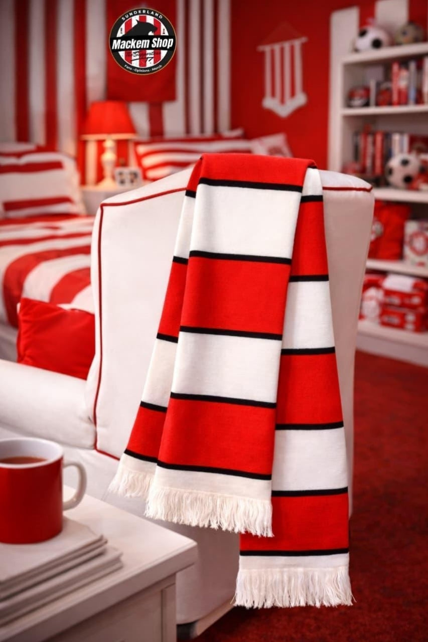 A red, white, and black striped knit scarf with white fringe is draped over a white armchair in a red, white, and black themed bedroom. A 'Madison Shop' logo is visible in the top left corner.