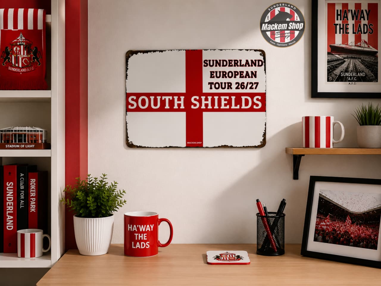 A rustic metal sign featuring the Sunderland football club colors, with a red St. George's cross on a white background and the text 'SUNDERLAND EUROPEAN TOUR 26/27 SOUTH SHIELDS'.