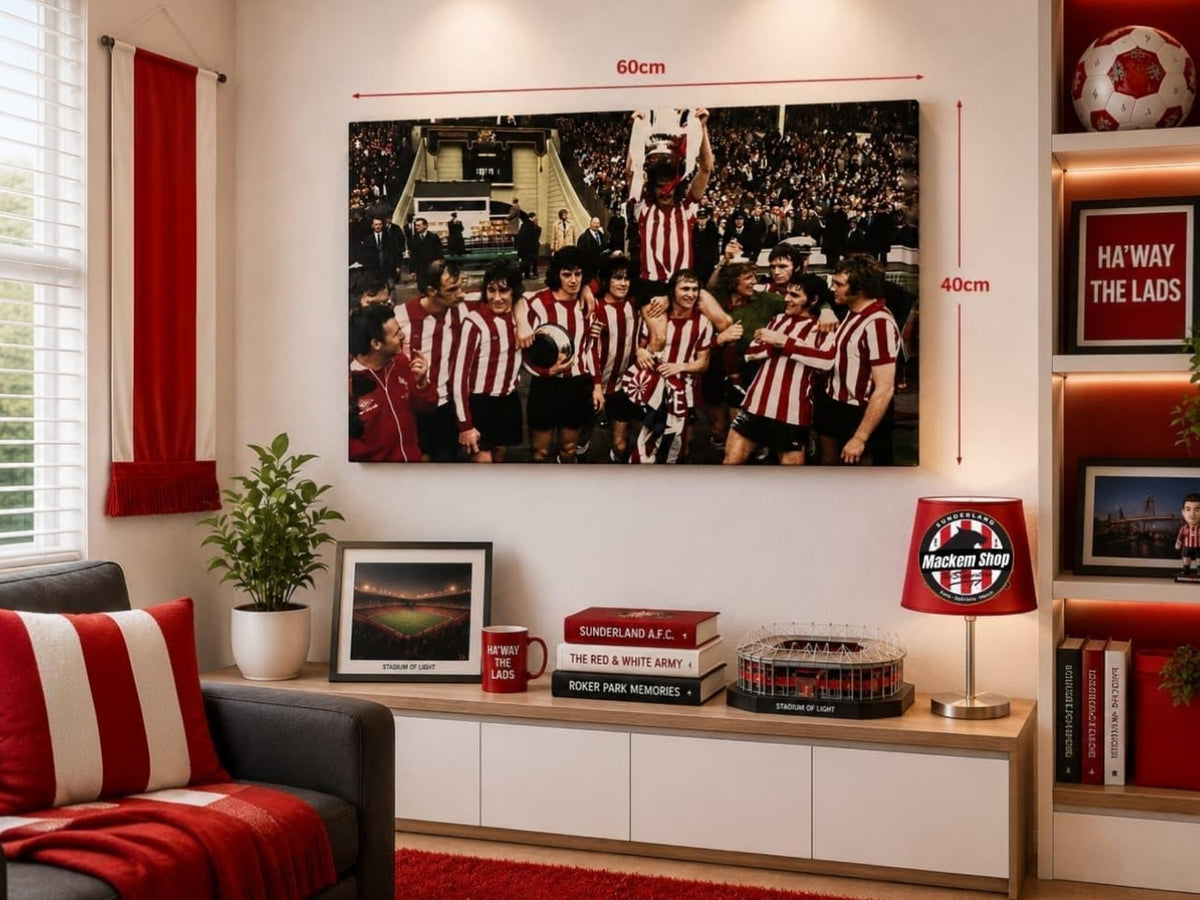 A large framed wall print showing a football team in red and white striped jerseys, displayed in a modern living room setting with red and white decor, size annotations of 60cm by 40cm, and a Sunderland A.F.