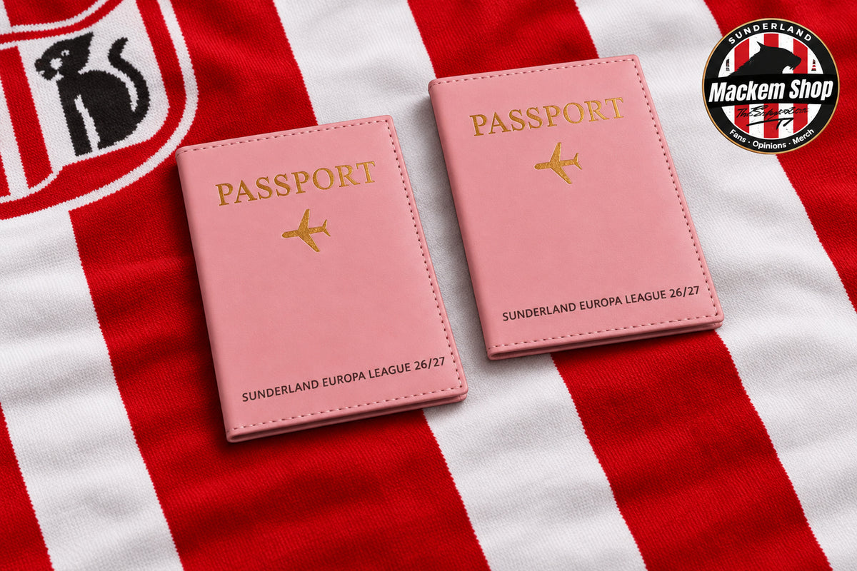 Two pink passport cover sleeves with gold foil lettering and airplane icons, displayed on a wooden table alongside Sunderland AFC themed merchandise including a scarf, framed sign, mug, and a MackemShop logo badge.