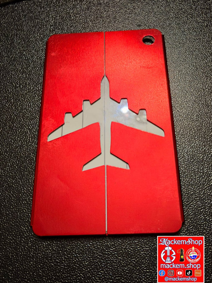 A red airplane silhouette design in the center, shown on a textured black surface. A 'MackemShop' logo is visible in the bottom right corner.