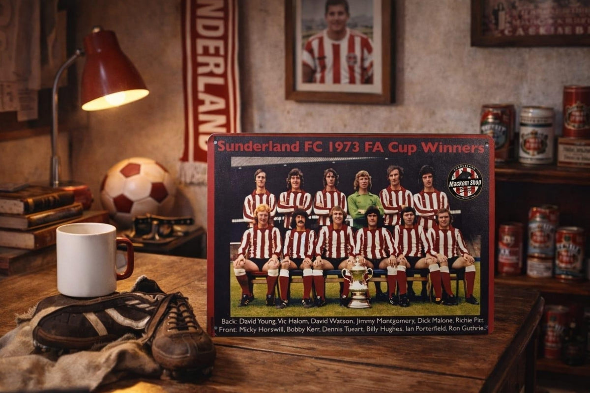 A vintage Sunderland FC 1973 FA Cup Winners Metal sign displayed on a wooden shelf in a cozy, dimly lit room with a lamp, mug, and soccer ball.