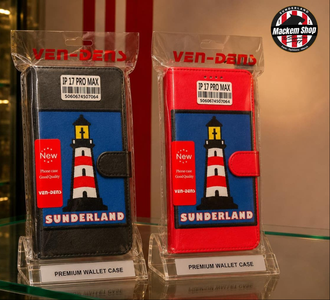 Two MackemShop product wallet cases in clear plastic packaging, displayed on a glass shelf. One case is black and the other is red, both featuring a blue front panel with a lighthouse graphic and the word 'SUNDERLAND'.