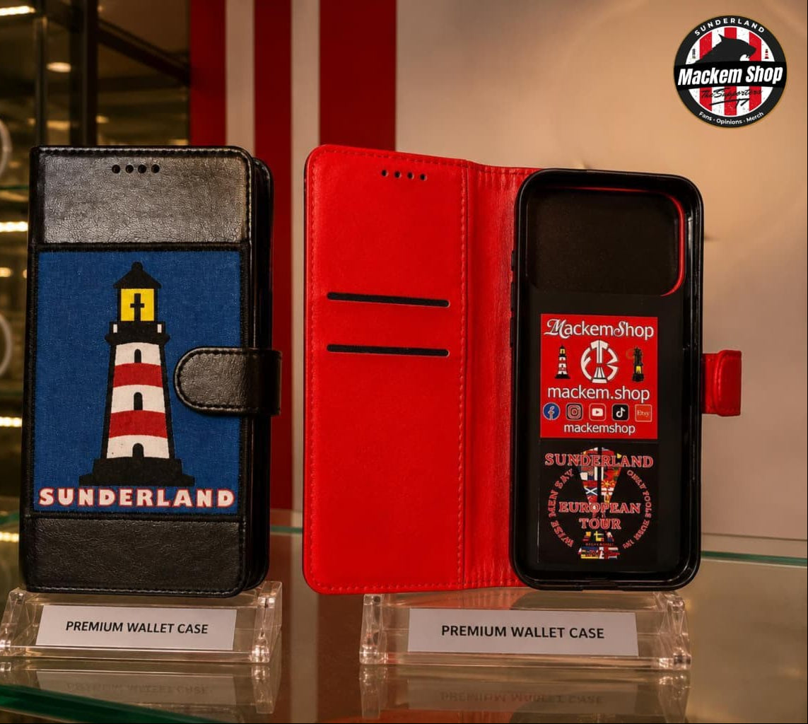Two premium wallet phone cases displayed on clear stands in a retail setting. The left case is black with a blue front panel featuring a red-and-white lighthouse and the word 'SUNDERLAND.