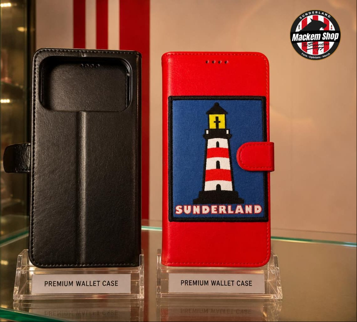 Two premium wallet phone cases displayed on clear acrylic stands on a glass shelf. The left case is black faux leather, and the right case is red with a large embroidered patch featuring a lighthouse and the text 'SUNDERLAND'.
