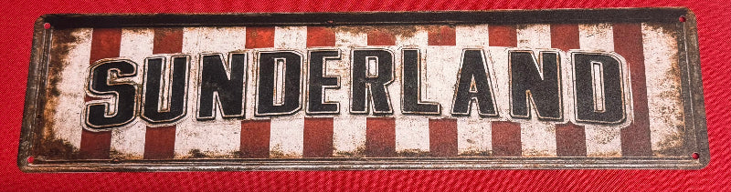 Decorative sign with 'SUNDERLAND' text on a red background