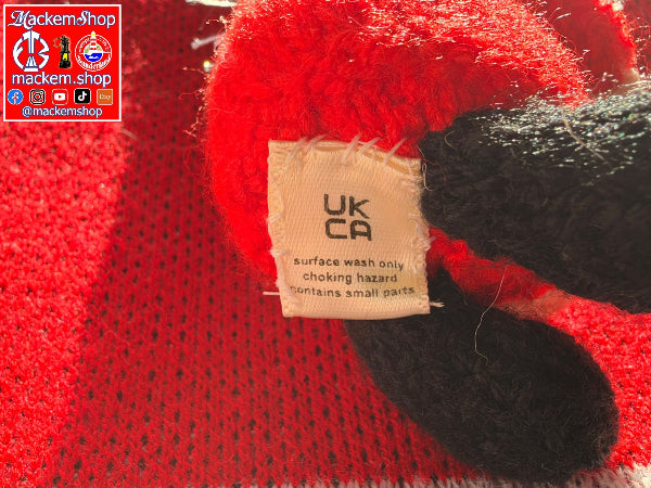 Close-up of a Gonk, showing a beige UK CA Surface wash only, choking hazard text. A MackemShop watermark appears in the top-left corner.