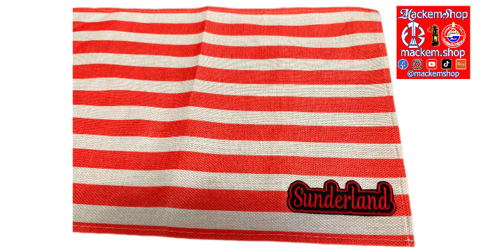 A red and off-white striped woven textile, likely a towel or blanket, featuring a black and red 'Sunderland' embroidered patch on the bottom right. A MackemShop logo overlay is visible in the top right corner.