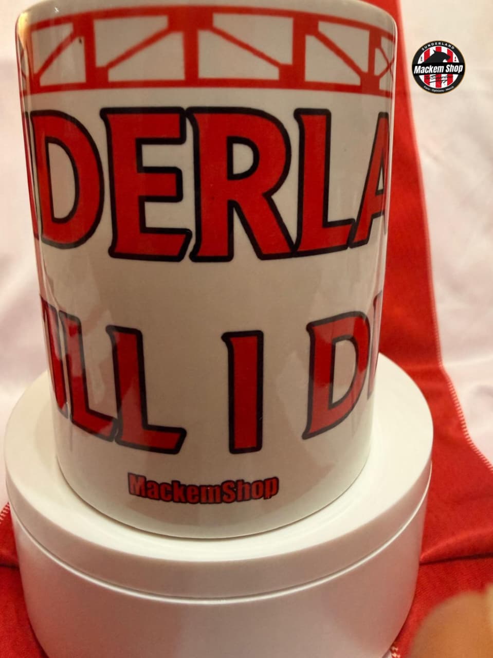 White mug with red and black text on a white background
