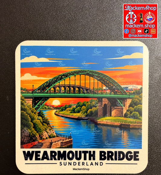 A square coaster featuring a colorful illustration of Wearmouth Bridge in Sunderland, placed on a rustic wooden table next to a glass of beer and snacks. A 'MackemShop' logo overlay is in the top right corner.
