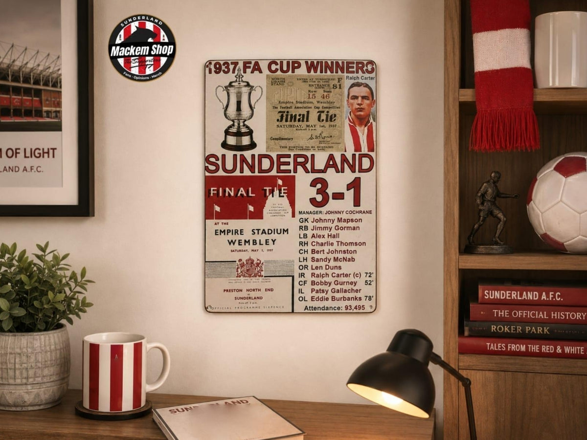 A vintage-style Sunderland FA Cup 1937 metal wall sign displayed on a wall in a cozy room setting, surrounded by a red and white striped mug, a black desk lamp, a potted plant, and a bookshelf with a red and white scarf and soccer ball.