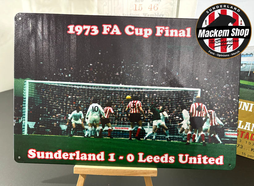 Metal sign commemorating the 1973 FA Cup Final between Sunderland and Leeds United, featuring a photo of the match and scores.
