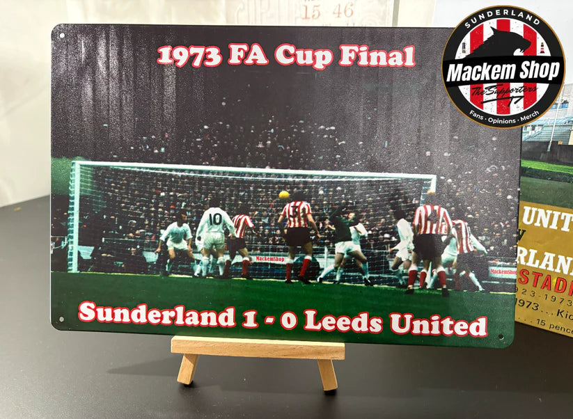 Metal sign depicting the 1973 FA Cup Final between Sunderland and Leeds United, featuring a soccer match scene.