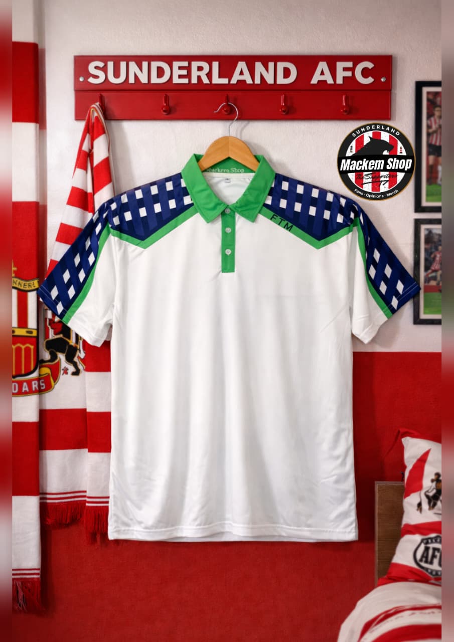 White polo shirt with green and blue accents hanging on a wooden hanger against a red wall with 'Sunderland AFC' branding.