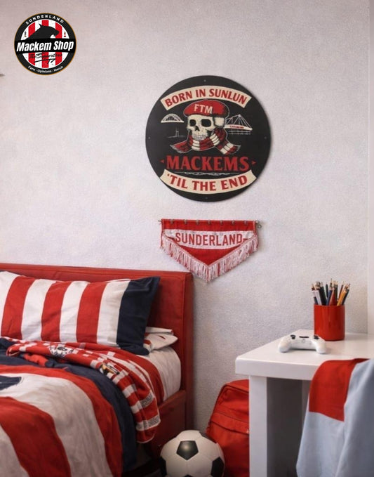 A themed bedroom scene featuring Sunderland football merchandise, including a circular black metal sign with a skull and the text 'BORN IN SUNLUN MACKEMS TIL THE END', a red and white 'SUNDERLAND' pennant, a red and white striped pillow, and a red, white, and blue striped blanket on a bed.