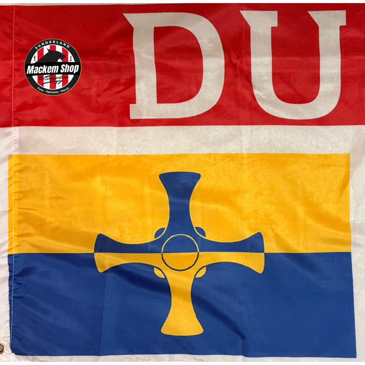 Flag with red, yellow, and blue horizontal stripes featuring a blue cross in the center, with 'DU' in white above and a logo on the top left corner.