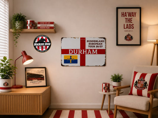 Living room with decor elements including a 'Durham' sign, framed pictures, and a lamp.