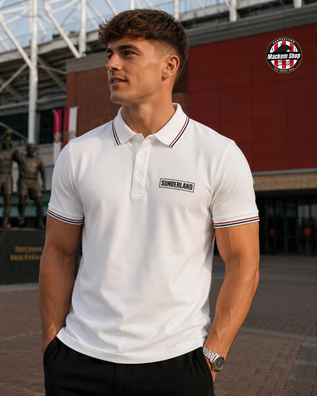 Man wearing a white polo shirt with 'Sunderland' logo outdoors.