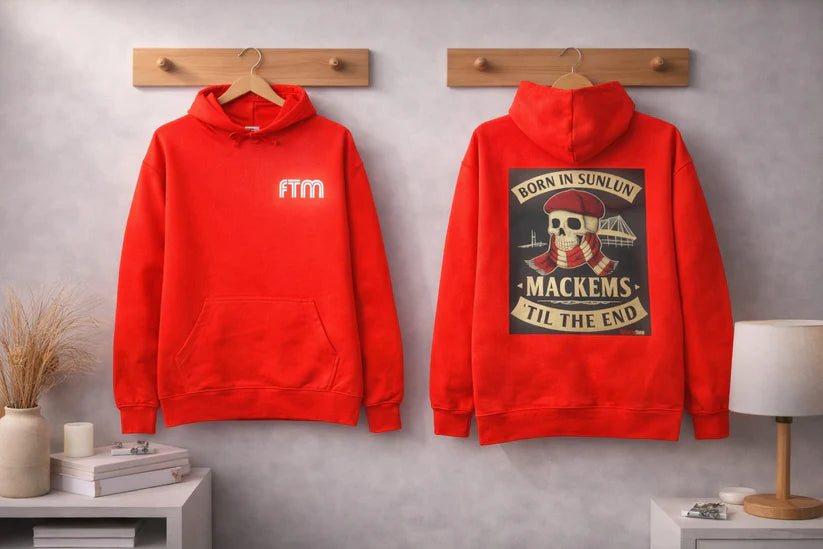 Red hoodie with 'FTM' text on front and graphic design on back against a gray wall.