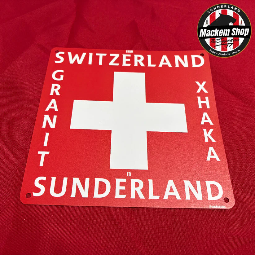 Red sign with Swiss cross and a Granit Xhaka text on a red background, featuring the Mackem Shop logo.