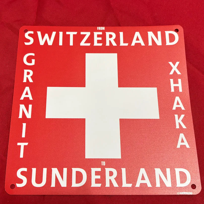 Red sign with white cross and text on a red background