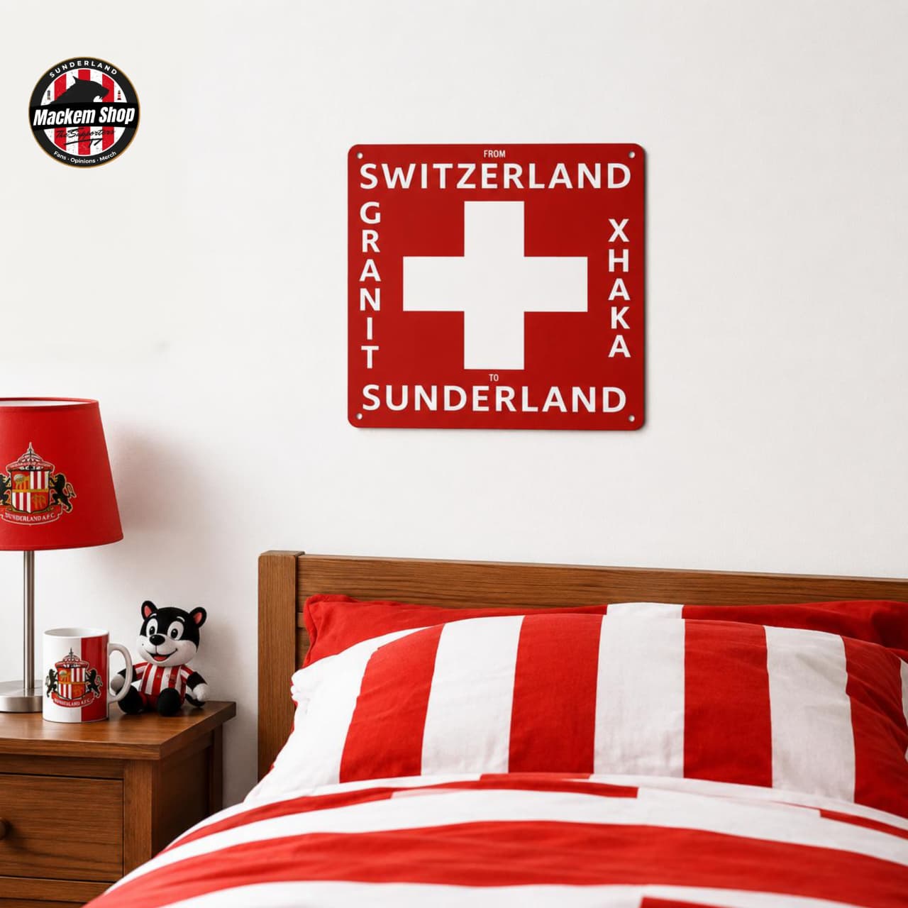 Bedroom with red and white bedding, lamp, and 'Switzerland Granit Xhaka Sunderland' Metal sign on the wall.