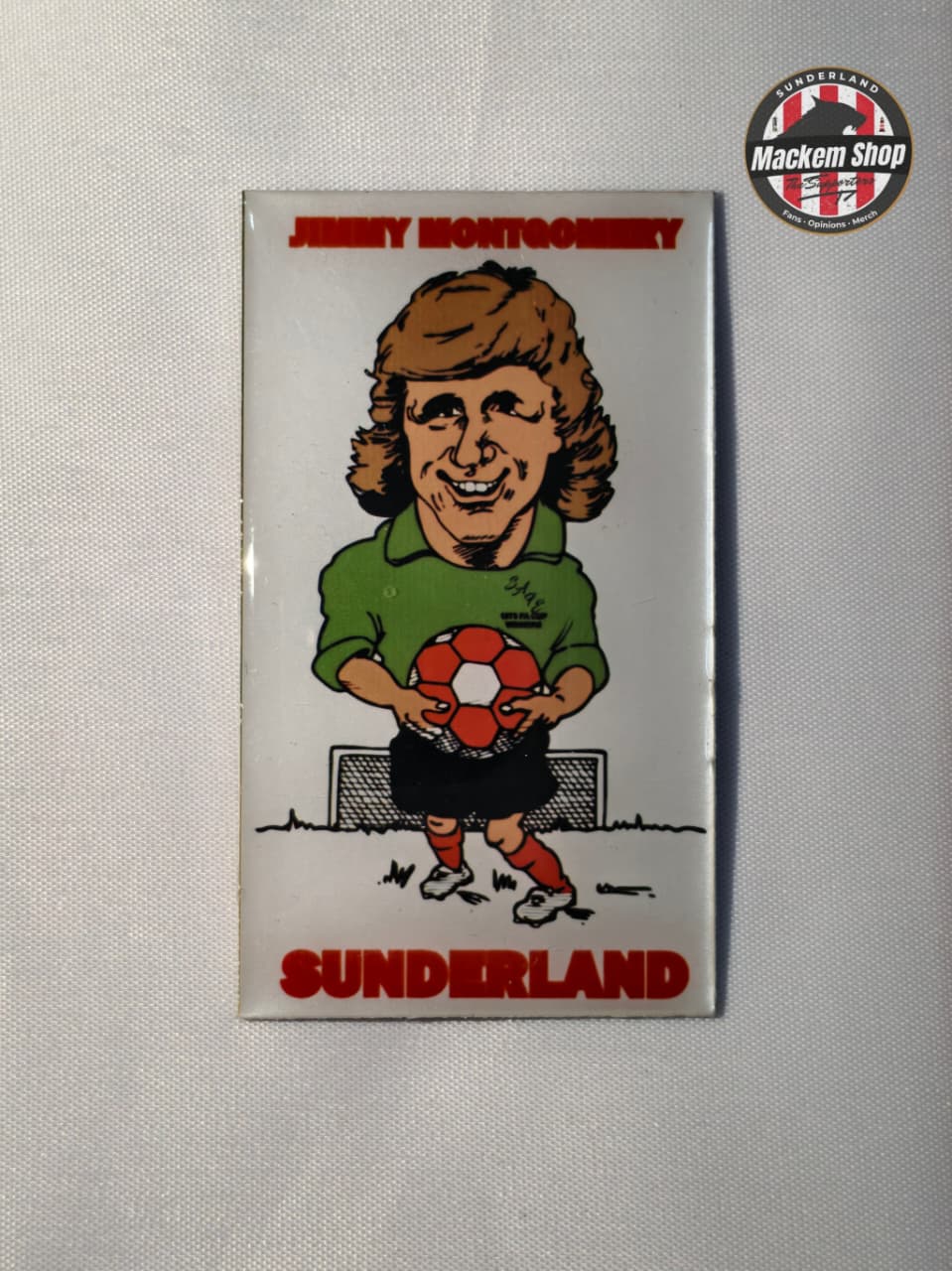 Fridge magnet with a caricature of a person holding a soccer ball, labeled 'Sunderland', on a gray background.