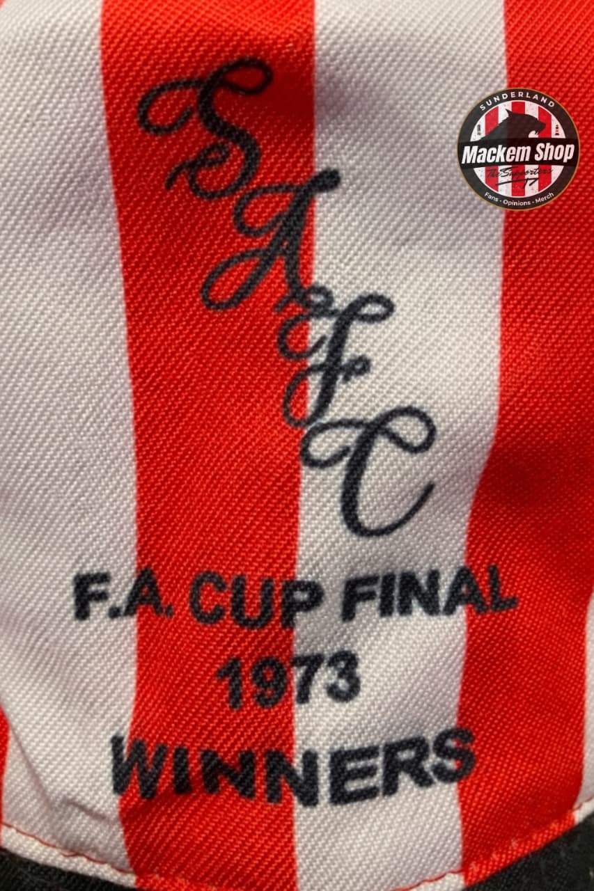 Red and white striped fabric with embroidered text 'Salford A.F.C. F.A. Cup Final 1973 Winners' and a logo in the corner.