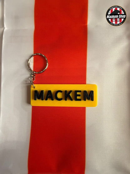Yellow keychain with 'MACKEM' text on a red and white striped background