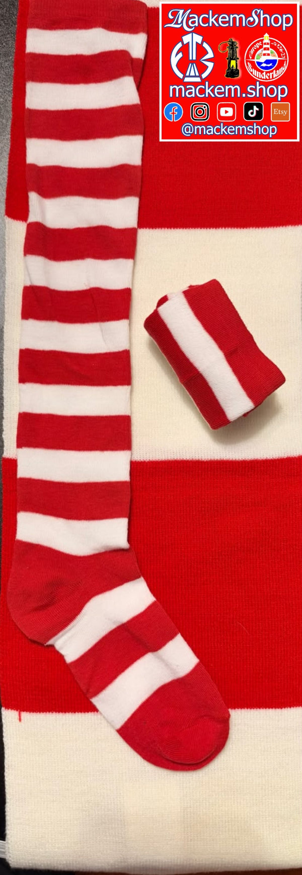 A pair of red and white striped knit socks displayed flat, with one sock laid out fully and the other folded. A red and white striped knit bootie is also shown. A MackemShop Logo is visible on the top right corner.