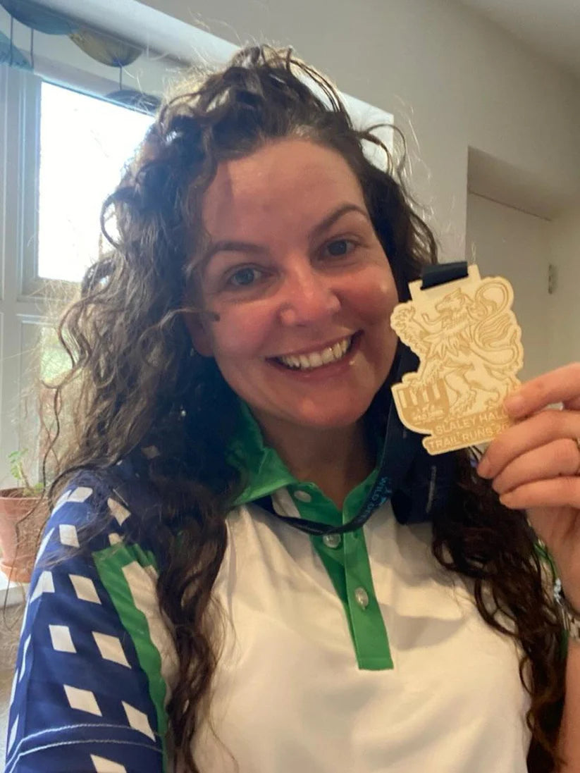 Women Holding a gold medal wearing golf polo shirt by Mackem shop