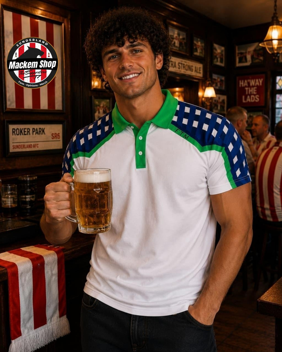 A man in a pub holding a glass of beer, wearing a white short-sleeve polo shirt with green and blue gingham patterned shoulder and collar details. A 'Mackem Shop' logo is visible on the wall behind him.