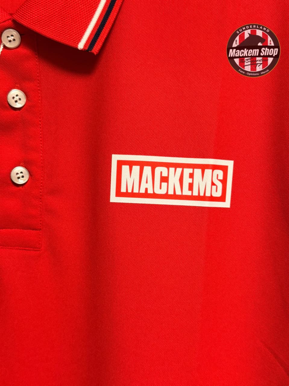 Red polo shirt with 'Mackems' logo and Mackem Shop badge