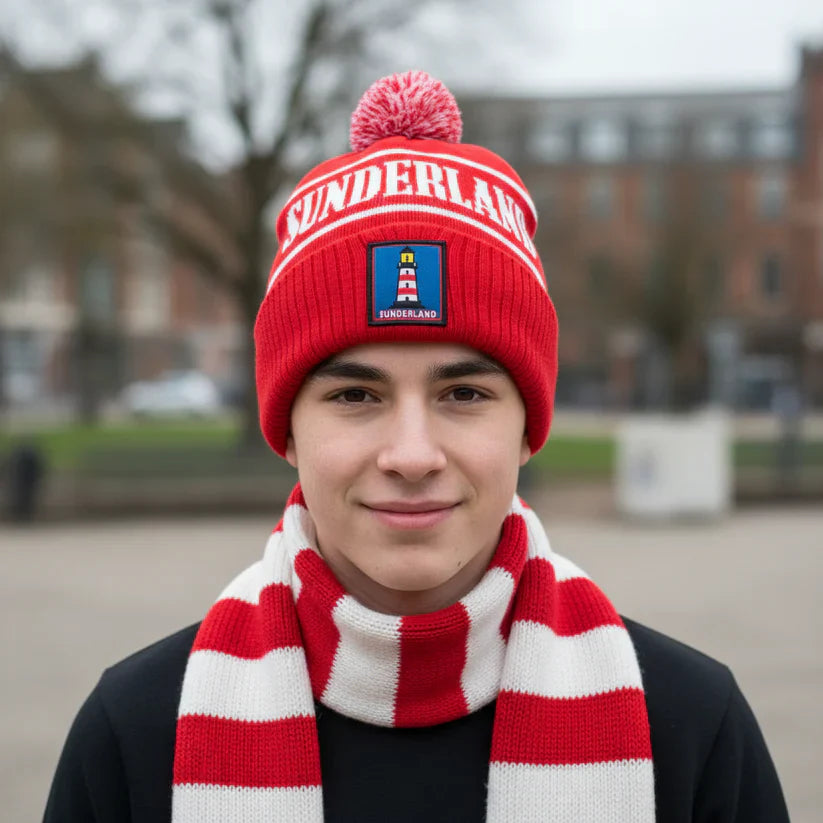 Person wearing a red 'Sunderland' beanie and scarf outdoors