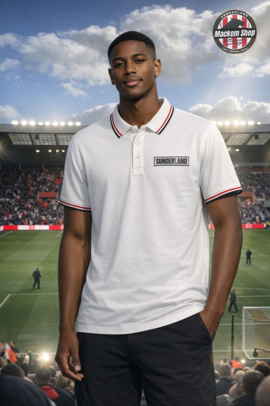 Person wearing a Sunderland white polo shirt with 'Sunderland' branding on a football stadium background