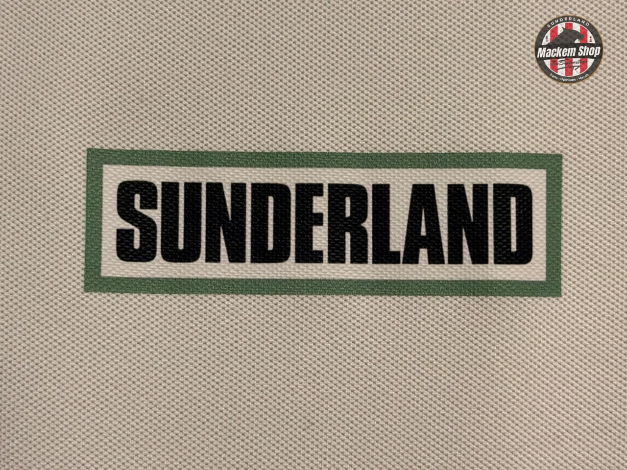 Text 'SUNDERLAND' on a textured beige background with a logo in the corner.