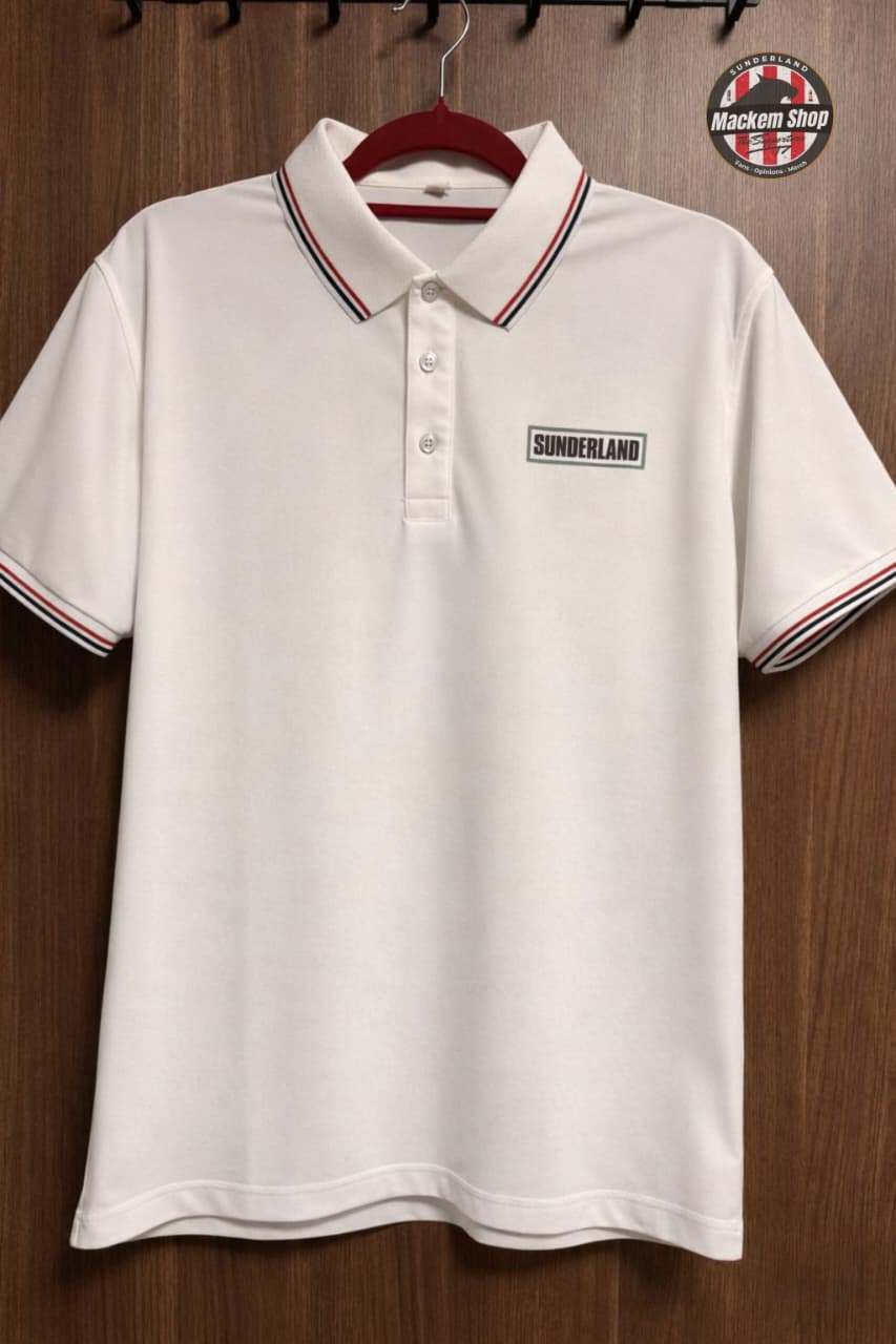 Sunderland White polo shirt with red and black trim on a hanger against a wooden background