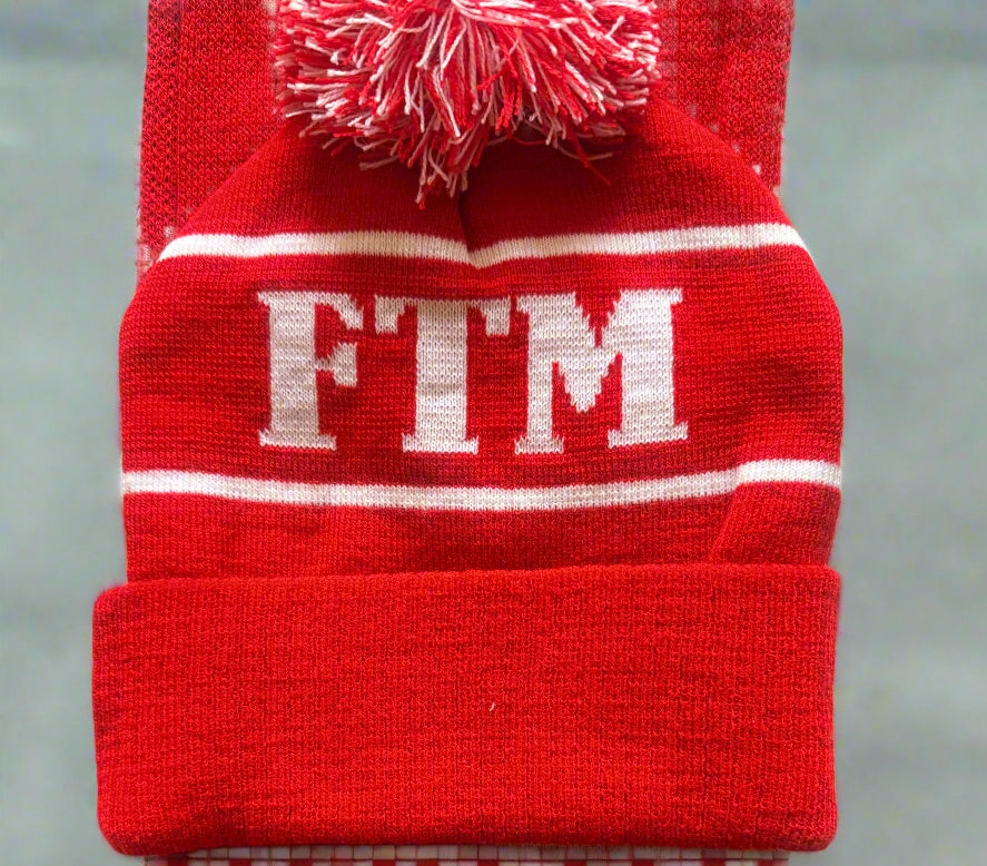 Red beanie with 'FTM' logo on a gray background