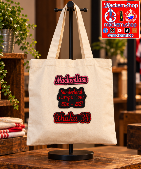 A beige colour tote bag on a bag holder with Mackemlass, Sunderland Europe tour 2026-27, and Xhaka 34 patches. A MackemShop logo is visible on top right corner.