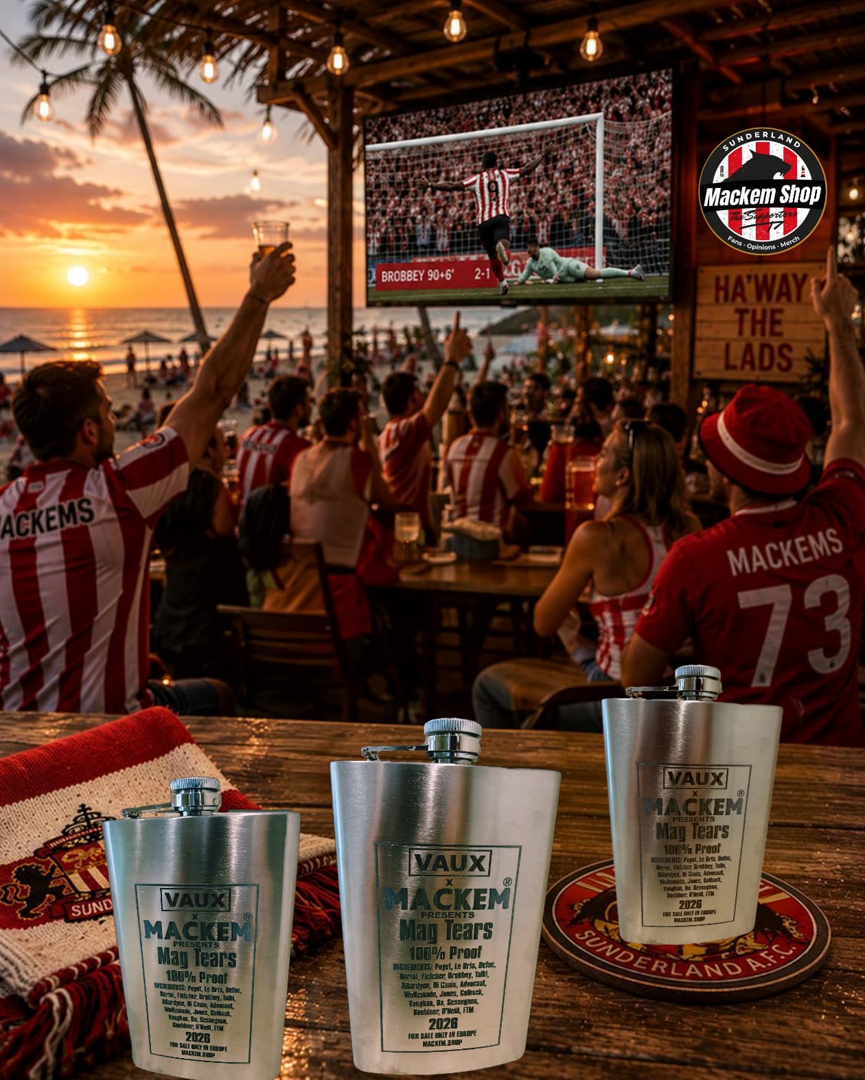Three silver Vaux Macken Highs Proff cups with metal flasks are displayed on a wooden table at a beachside bar, with fans wearing red and white striped jerseys cheering in the background during sunset.