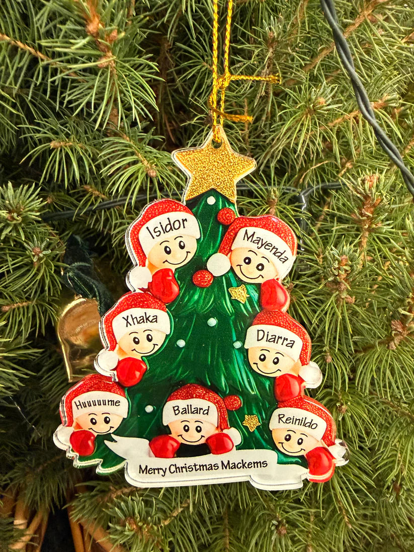 Personalized Christmas tree ornament with children's faces and names on a green tree.