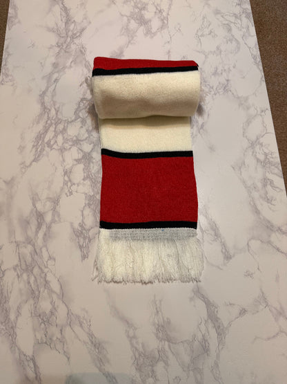 Red and white scarf with black stripes on a marble surface