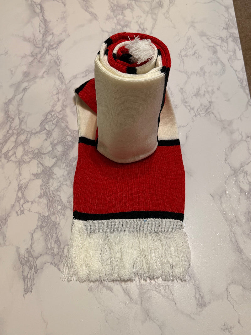 Roll of insulation material with a red and black border on a marble surface