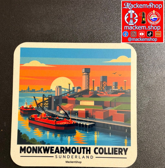 A square coaster featuring a colorful illustration of the Monkwearmouth Colliery in Sunderland, with a red ship, cranes, and an industrial landscape at sunset. The coaster is displayed on a dark textured surface, with a red 'mackemshop' logo in the top right corner.
