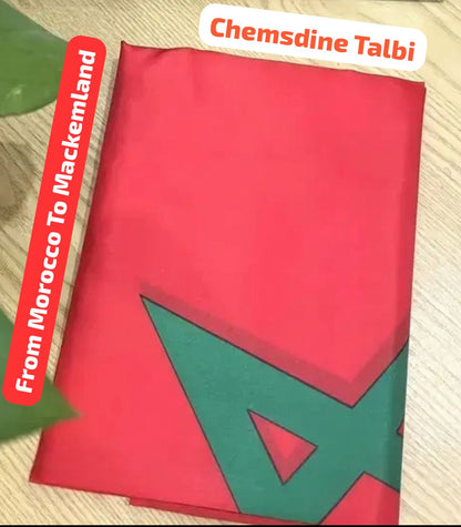 Red and green fabric with geometric patterns on a wooden surface, featuring text 'Chemsdine Talbi' and 'From Morocco To Mackenland'.