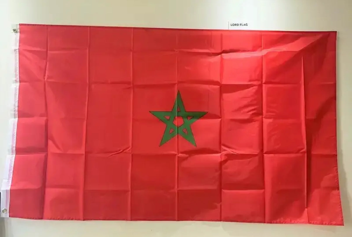 Red flag with a green star on a white background